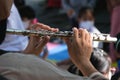 Close-up of the hands of a musician playing the flute. Hands of man playing a flute Royalty Free Stock Photo