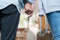 Close up hands of new marriage couple holding new house key together. Young attractive romantic man and woman holding suitcase Royalty Free Stock Photo