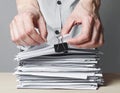Business Person Sorting Documents with Paperwork and Binder Clip Royalty Free Stock Photo