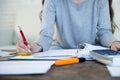 Close up hands with pen of woman suffering stress doing domestic accounting paperwork bills