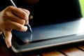 Close up Hands with pen writing on the modern graphic tablet Royalty Free Stock Photo