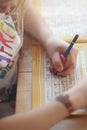 close up on hands and pen of young blonde left-handed girl training her handwriting at home