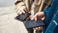 Close up of hands of people holding smartphones. Male hand touching screen, using mobile phone. Shot with third person Royalty Free Stock Photo