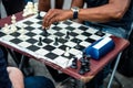 Close up of hands of people playing quick chess on the street with timer