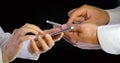 Close - up of hands of people using phone for application and wireless network concept. Black isolated background. Royalty Free Stock Photo