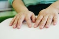 Close-up hands of person woman with blindness disability using fingers reading Braille book studying in library. Braille is a Royalty Free Stock Photo