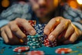 A close-up of the hands of a player at the table making a bet with playing chips. A poker game Royalty Free Stock Photo