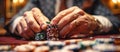 A close-up of the hands of a player at the table making a bet with playing chips. A poker game. Panoramic banner. Royalty Free Stock Photo