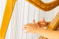 Close up hands playing celtic harp