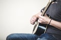 Close up of hands playing guitar