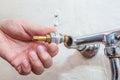 Close-up hands plumber install tap valve to kitchen water faucet Royalty Free Stock Photo