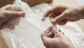 Closeup of hands popping bubble wrap a common stressrelief activity and packaging material Royalty Free Stock Photo