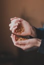 Close-up of hands that pour large yellow capsules of vitamins from one hand to another Royalty Free Stock Photo