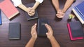 Close up hands praying on Bible at home, church in home, devotional or prayer meeting concept, Religion concept