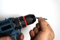 Hands holding drill bit for power tool installation Royalty Free Stock Photo