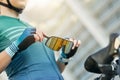 Close up of hands of professional female cyclist holding and putting on protective glasses while getting ready for