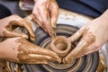 Close-up of Hands of Professional Male Potter Teaching His Female Apprentice