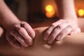Close-up of the hands of a professional massage therapist men doing wellness massage shins and legs for a client to a Royalty Free Stock Photo