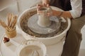 Close up of artisan& x27;s hands shaping clay bowl in pottery studio. Pottery art and creativity Royalty Free Stock Photo