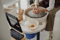 Close up of artisan& x27;s hands shaping clay bowl in pottery studio. Pottery art and creativity Royalty Free Stock Photo