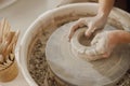 Close up of artisan's hands shaping clay bowl in pottery studio. Pottery art and creativity Royalty Free Stock Photo