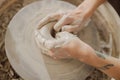 Close up of artisan's hands shaping clay bowl in pottery studio. Pottery art and creativity Royalty Free Stock Photo