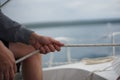 Close up of hands holding a rope, sheet on a sailboat