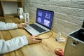 Close-up of the hands of a doctor dentist radiologist analyzing panoramic dental X-ray on laptop screen monitor in dentists office