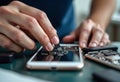 precise removal of phone display, technician carefully separates phone screen from device frame Royalty Free Stock Photo