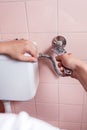 Close-up of a hands repairing toilet