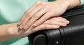 Close-up of Hands Resting on a Modern Black Travel Suitcase for Adventure Royalty Free Stock Photo