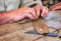 Close up of hands rolling a cigar