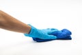 Close up of hands in rubber protective blue gloves cleaning the blue surface with a rag