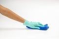 Close up of hands in rubber protective green gloves cleaning the blue surface with a rag Royalty Free Stock Photo