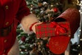 Close-up of hands of santa claus puts a gift in a mailbox. Christmas miracle