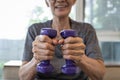 Close Up,hands of senior people holding dumbbells while working out,old elderly lifting dumbbell weights,daily workouts at home, Royalty Free Stock Photo