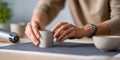 Close-up of hands shaping a small ceramic cup on a pottery wheel in a creative studio environment with blurred background Royalty Free Stock Photo