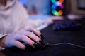 Close-up hands shot asia girl gamer use keyboard and mouse controller play video game with neon light computer in desk