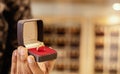 Close up, hands showing Gold Ring at jewelry box with copy space at jewellery store. Royalty Free Stock Photo