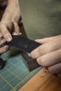 Hands Showing Rivet Hole in a Leather Strap