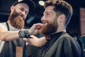 Close-up of the hands of a skilled barber using a brush