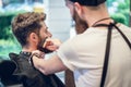 Close-up of the hands of a skilled barber using a brush