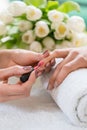 Hands of a skilled manicurist applying red nail polish on the na Royalty Free Stock Photo