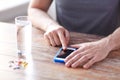 Close up of hands with smartphone, pills and water Royalty Free Stock Photo