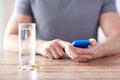 Close up of hands with smartphone, pills and water Royalty Free Stock Photo