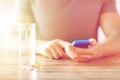 Close up of hands with smartphone, pills and water Royalty Free Stock Photo