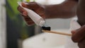 Close up hands squeezing out white toothpaste from tube on toothbrush dental care morning procedure oral hygiene prevent Royalty Free Stock Photo