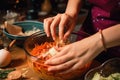 close-up of hands stirring ingredients together to create delicious meal