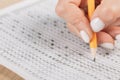 Students hands to take exams, writing an exam room with a pencil holding on an optical form of a standardized test with answers Royalty Free Stock Photo