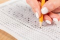 Students hands to take exams, writing an exam room with a pencil holding on an optical form of a standardized test with answers Royalty Free Stock Photo